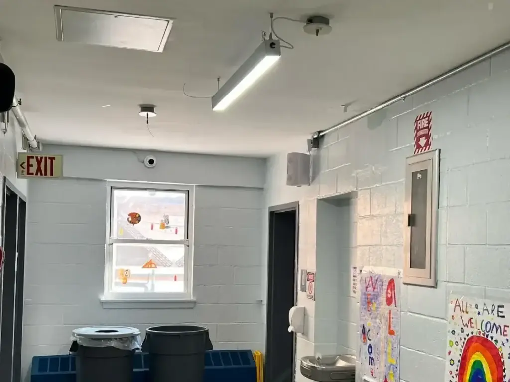School hallway at Academy of the City with a dome camera and PA speaker installed by Solved IT