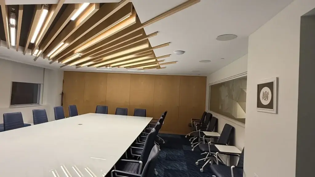 Cogency Global boardroom with a ceiling-mounted UniFi Wi-Fi 7 access point