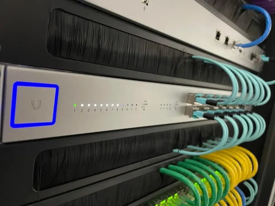 UniFi 10G switch with aqua DAC cables in Ethic network rack