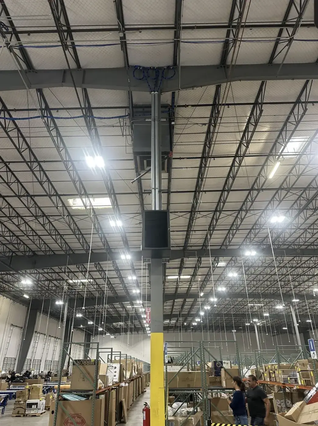 Manufacturing IT, Physical Security & Cabling in NYC, NJ & CT 1 Network rack mounted on a column above a busy warehouse floor, installed by Solved IT